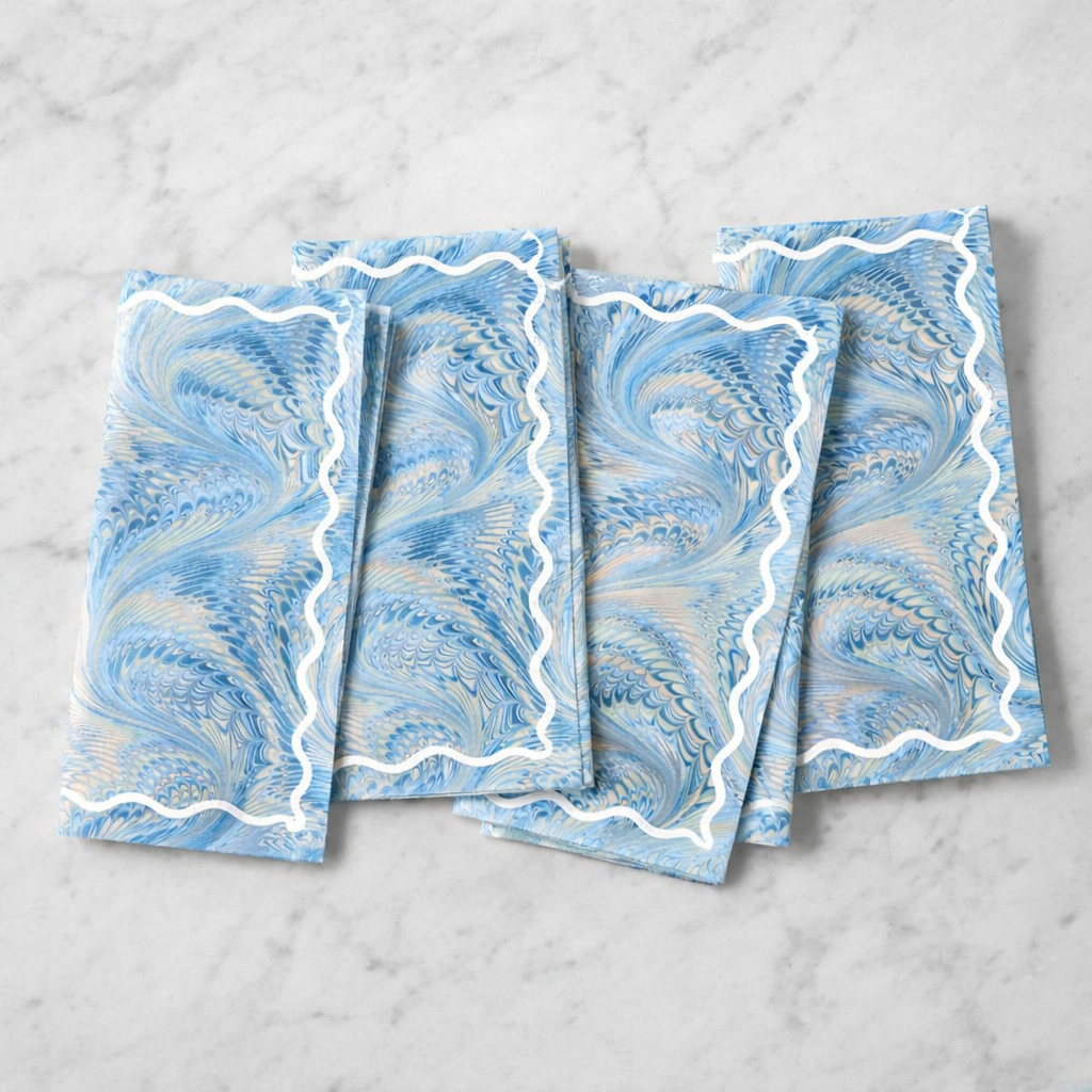 Set of four blue marbled napkins with white wavy embroidery